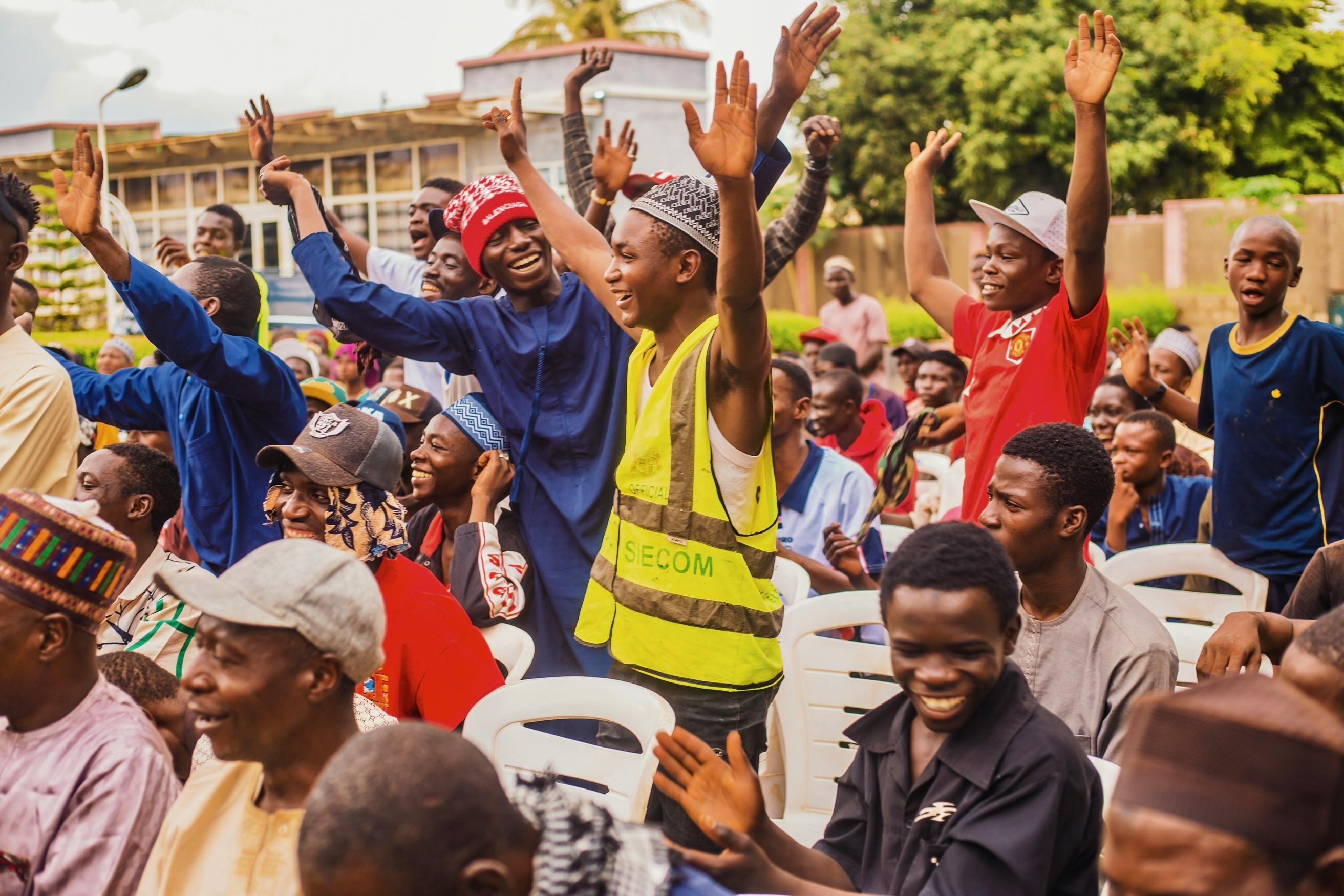 Joyful community gathering in West Africa — vibrant local engagement and market opportunity
