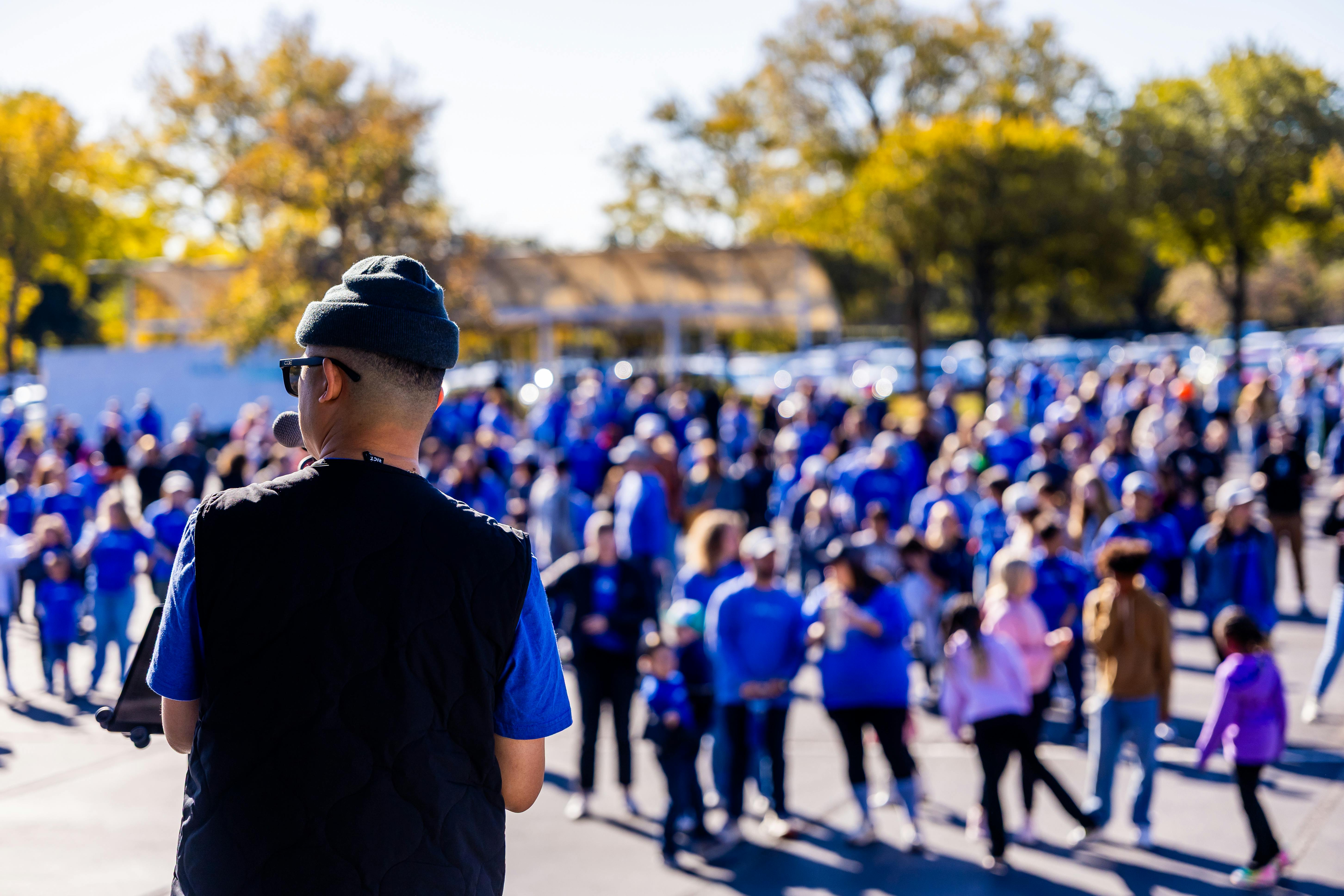 Community leader addressing a large crowd — civic engagement and collective action