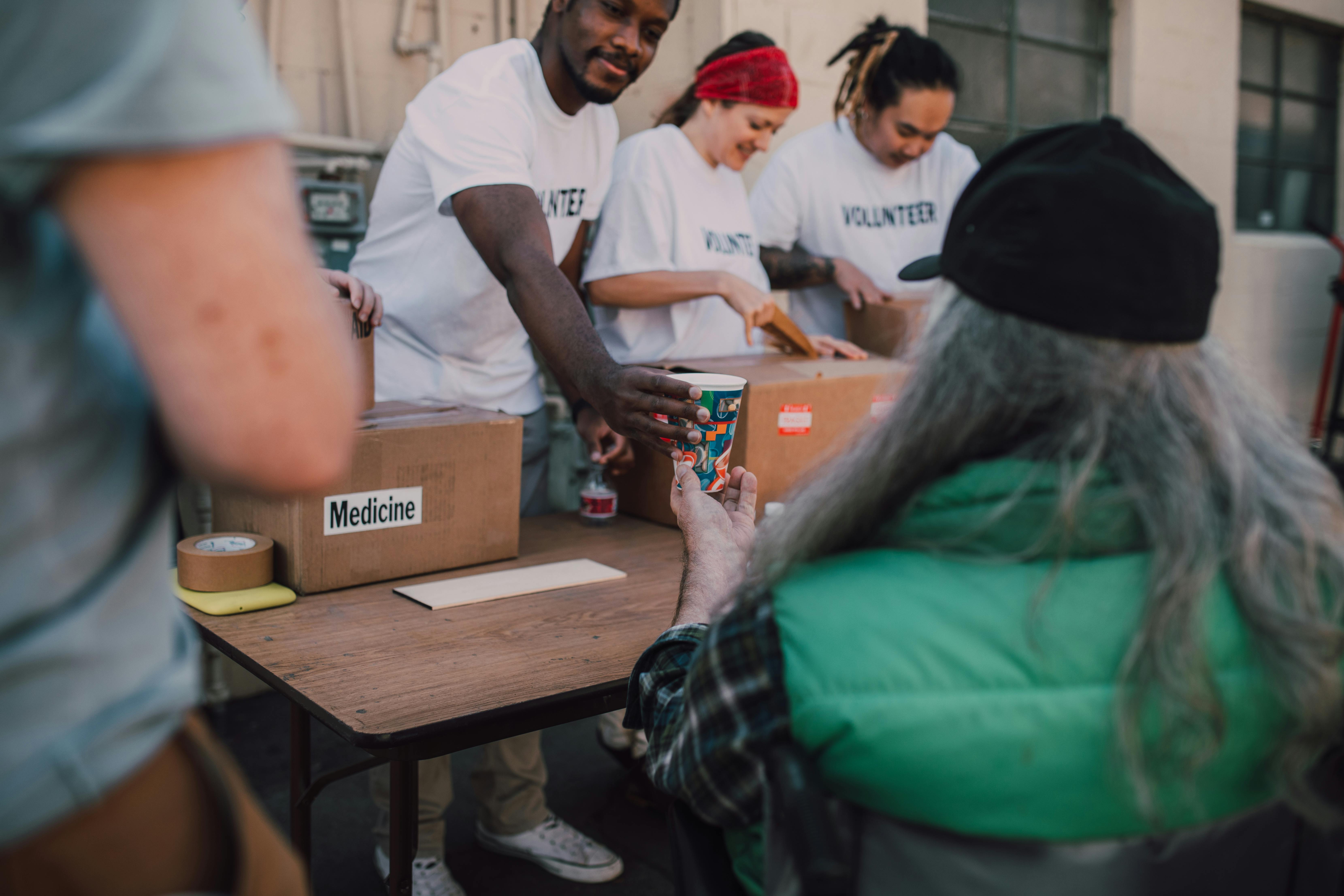 Volunteers distributing supplies to community members in need — accountability and service in action
